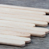 A disposable wooden agitator in a coffee cup